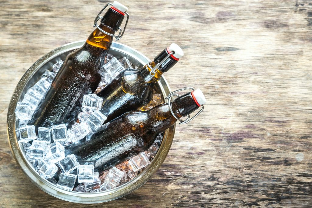 Bottles of beer in ice cubes